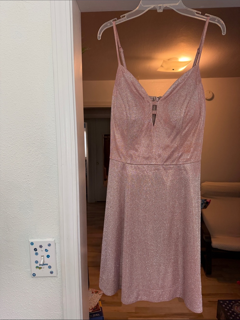 pink glittery mini dress with spaghetti straps and a V-neckline